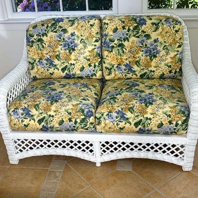 CUSHIONED 2-SEAT WICKER SOFA | White painted wicker loveseat with floral patterned cushions. - l. 53 x w. 32 x h. 34 in

