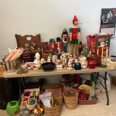 Table filled with Holiday /Christmas decor; Nutcracker Style Pinocchio, angel votive candles, Santa candy tray, soap dishes, and misc....