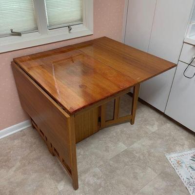 Mid Century Modern  ....was stunning - drop leaf teak table. The center section has had poly coating applied - awesome restoration piece! 