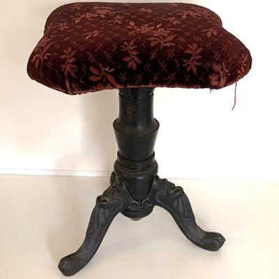 Antique piano stool with cast iron legs, cast with woman's face