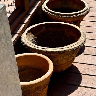 Many flower pots, some include plants