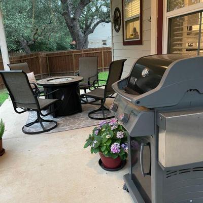 Firepit table, 4 swivel patio chairs. Weber gas grill. Numerous potted flowering plants