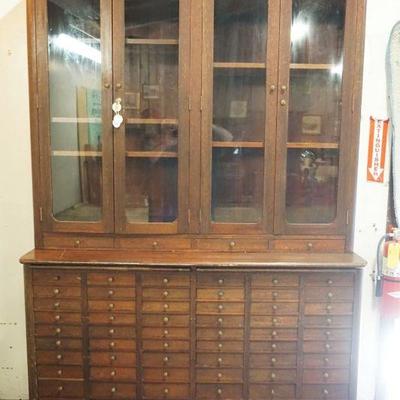 1235	ANTIQUE MAHOGANY COUNTRY 2 PIECE STORE APOTHECARY CABINET, TOP HAVING 4 GLASS DOORS & BASE HAVING 72 DRAWERS & 2 PULL OUT SURFACES,...