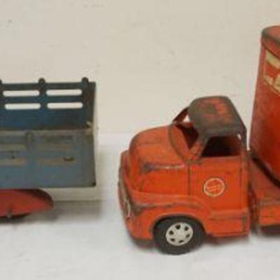 1099	2 ANTIQUE PRESSED STEEL TOY TRUCKS, LIVE STOCK & STAKE BODY, LARGEST APPROXIMATELY 23 IN LONG
