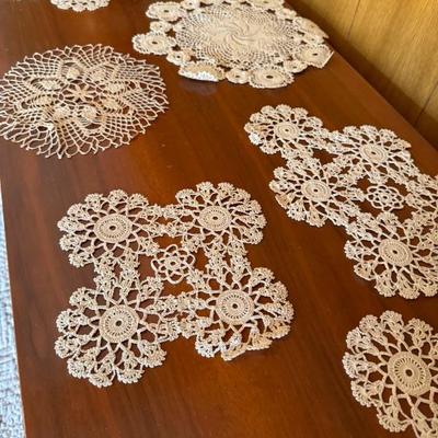 Large lot of intricate doilies of various designs