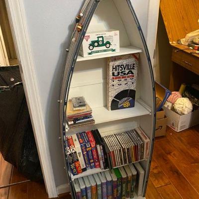 Painted Boat made into book case with DVDs, VHS, CDs two more in garage
