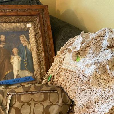 Large collection of crochet doilies and Framed Antique of Joseph, Mary, Jesus behind glass and Coach Handbag