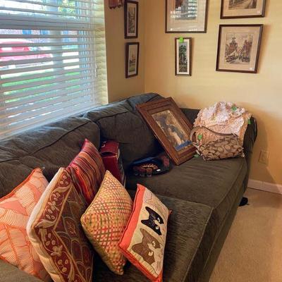 Corduroy couch with adorable decorative pillows and artwork