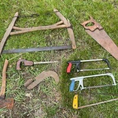 Hacks And Saws Lot
Vintage tree saw. Four hand saws. Wood saw. Hatchet. And top of a brush axe or bill hook. 