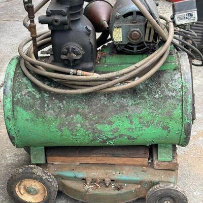 Antique Air Compressor Mounted On Large Tank
