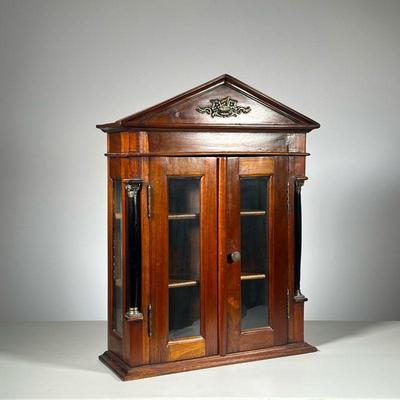 ANTIQUE COLUMN DISPLAY CABINET | Mahogany Cabinet with two black & brass columns. Two doors open to two shelves. - l. 19 x w. 6.76 x h....