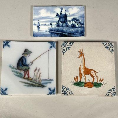 (3PC) PAINTED DELFT TILES | Includes; giraffe, fisherman scene, and windmill on the riverside. - l. 5 x w. 5 in


