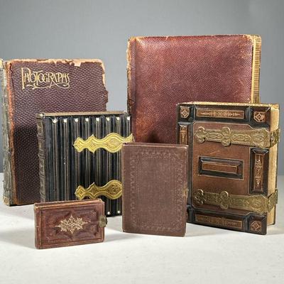 (6PC) SET OF PHOTO ALBUMS | Including one small book of headshots, a small book of portraits, a medium family photo album, a medium book...