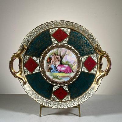 BEEHIVE SHIELD MARK PLATTER | Hand Painted Handled Circular Platter with Cupid and Woman. Marked with the blue Beehive/Shield and...