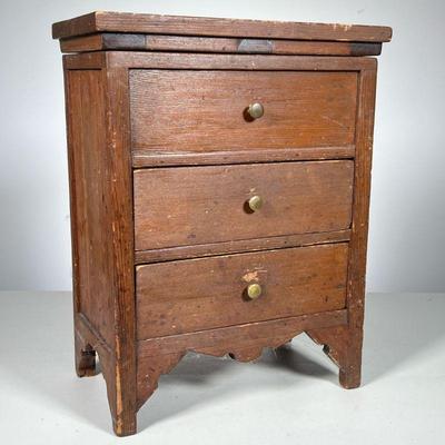 MINIATURE BLANKET CHEST | Top drawer is false, over two drawers. Top opens for storage. Pine. - l. 11 x w. 6.25 x h. 14 in

