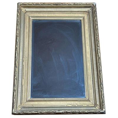 BEVELED GLASS MIRROR IN GILT FRAME | Beveled glass mirror in formed gilt frame. - l. 22.75 x w. 3.5 x h. 31 in

