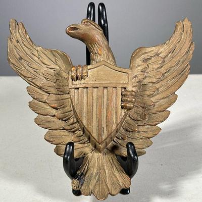(1PC) CARVED FEDERAL EAGLE | Well-carved spread-wing eagle clutching a shield. Folk art. - l. 8 x w. 7 in

