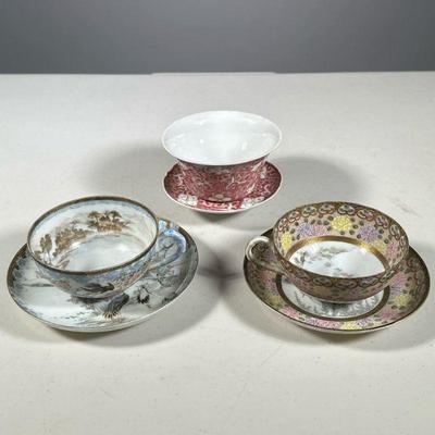 (3PC) JAPANESE TEACUPS | Delicately painted Japanese teacups and saucers showing nature scenes with floral and avian decorations. - h. 3...