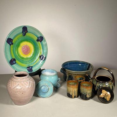 (8PC) ART POTTERY LOT | Lot includes: (4) Piece Mottled Teapot and tumblers. (1) Skull Plate in green. (1) Handled bowl in blue/grey. (2)...