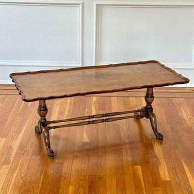 SERPENTINE TOP LOW TABLE | Having figured cabriole legs joined by a double stretcher. - l. 48 x w. 22 x h. 19 in

