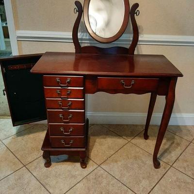 Vanity with mirror and side door which opens to reveal hanging jewelry storage. $85