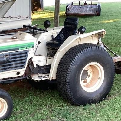 Bolens diesel garden tractor with mower and blade.