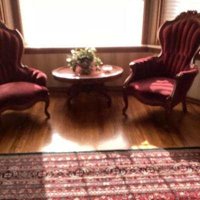 Red velvet parlor chairs with matching table