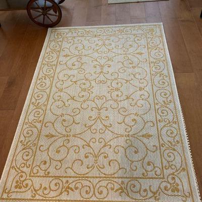 Small white rug with golden design