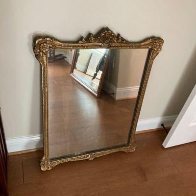 Wall mirror with ornate frame