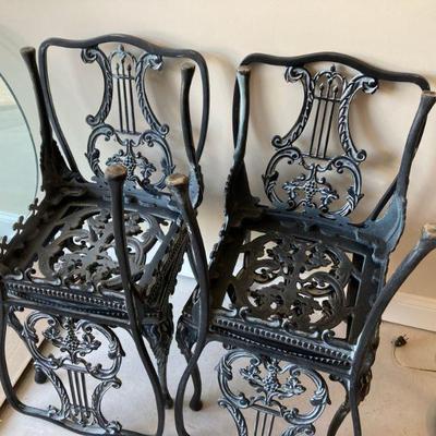 Set of four wrought iron patio chairs, part of table set