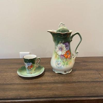 Floral tea set with pitcher, cup, and saucer