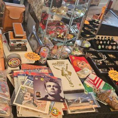 Stamp collecting books, bag of baseball and hockey cards, vintage Polaroid land camera and more!