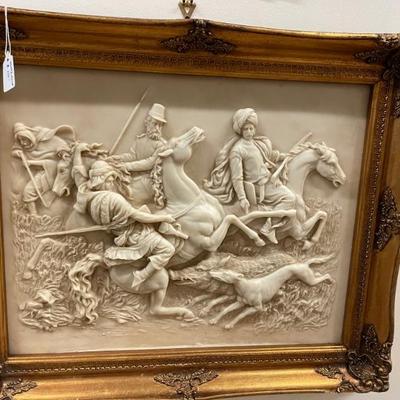 Hi relief carving of hunting scene