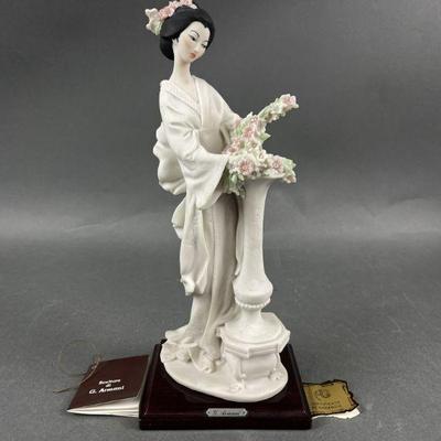 Lot 554 | G. Armani Sculpture of Lady with Flowers