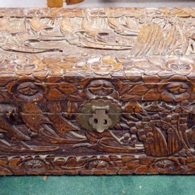 1063	HEAVILY CARVED ASIAN WOOD STORAGE CHEST, CARVING ALL AROUND W/INTERIOR GLOVE BOX, APPROXIMATELY 32 IN X 15 IN X 15 IN HIGH
