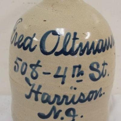 1169	BLUE SCRIPT STONEWARE JUG, HARRISON NJ, FRED OLTMANOS, APPROXIMATELY 11 IN H, CHIP ON SPOUT
