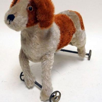 1184	ANTIQUE MOHAIR DOG PULL TOY WITH GLASS EYES, APPROXIMATELY 7 IN X 12 IN X 11 IN H

