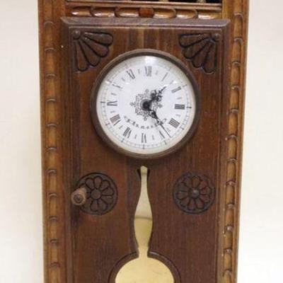 1114	MINIATURE 1 DOOR CARVED CABINET CLOCK CASE WITH SPRING WOUND CLOCK, CASE APPROXIMATELY 4 IN X 5 1/2 IN X 14 IN H
