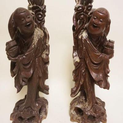 1050	2 LARGE WOOD ASIAN CARVED FIGURES, EACH APPROXIMATELY 22 IN HIGH, BOTH HAVE CANDLE WAX RESIDUE
