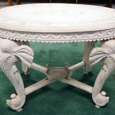 1071	WHITE PAINTED OVAL CARVED WOOD TABLE W/ELEPHANT HEADS & TUSKS LEGS, SOME LOSS TO CARVINGS, APPROXIMATELY 36 IN X 24 IN X 26 IN HIGH
