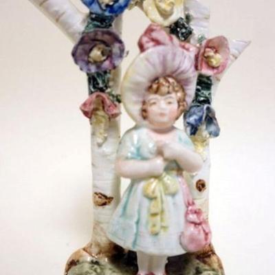 1110	ANTIQUE CERAMIC FIGURAL BUD VASE, IMAGE OF YOUNG GIRL UNDER TRELLIS, APPROXIMATELY 6 1/2 IN H
