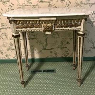 Antique Neoclassical Style Painted Wood Table features dental molding, faux bronze mounts, square tapering legs and replacement marble top. 