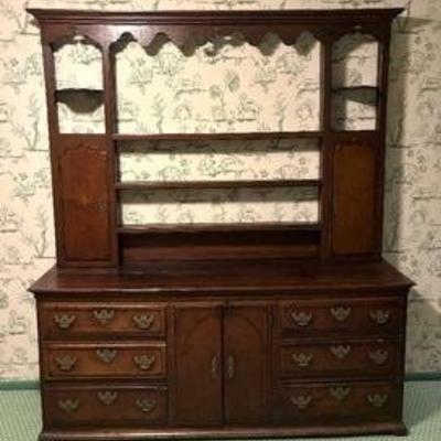 Antique Oak and Mahogany Veneer English Dresser in two parts with scrolled cornice, plate shelves flanked by two cabinet doors. 

The...