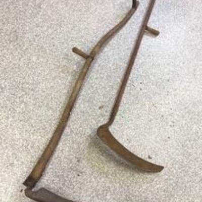 Two Vintage Sickles in used condition, measuring approximately 62 inches long.
