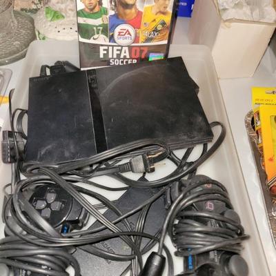 PlayStation 2 with controllers and game