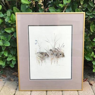 Beautiful circa 1970s vintage print, “Harekelinger” of three bunnies nestled in the grass by Danish watercolor artist, Mads Stage....