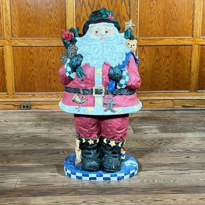MONUMENTAL WOOD-CARVED SANTA SCULPTURE | Large carved wood and painted Santa figurine with checkered base. Top half and legs separate...