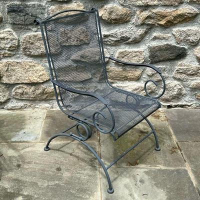 IRON SPRING BACK PATIO CHAIR | Having wrought iron arms and frame with rocking back from spring and curved legs. - l. 26 x w. 24 x h....