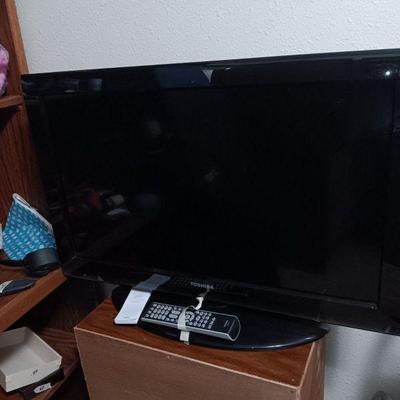 One of two flat screen TVs with remote (55