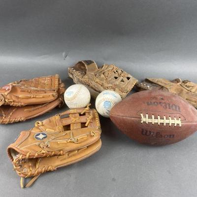 Lot 264 | Vintage Baseball Mitts, Football & 2 Softballs
